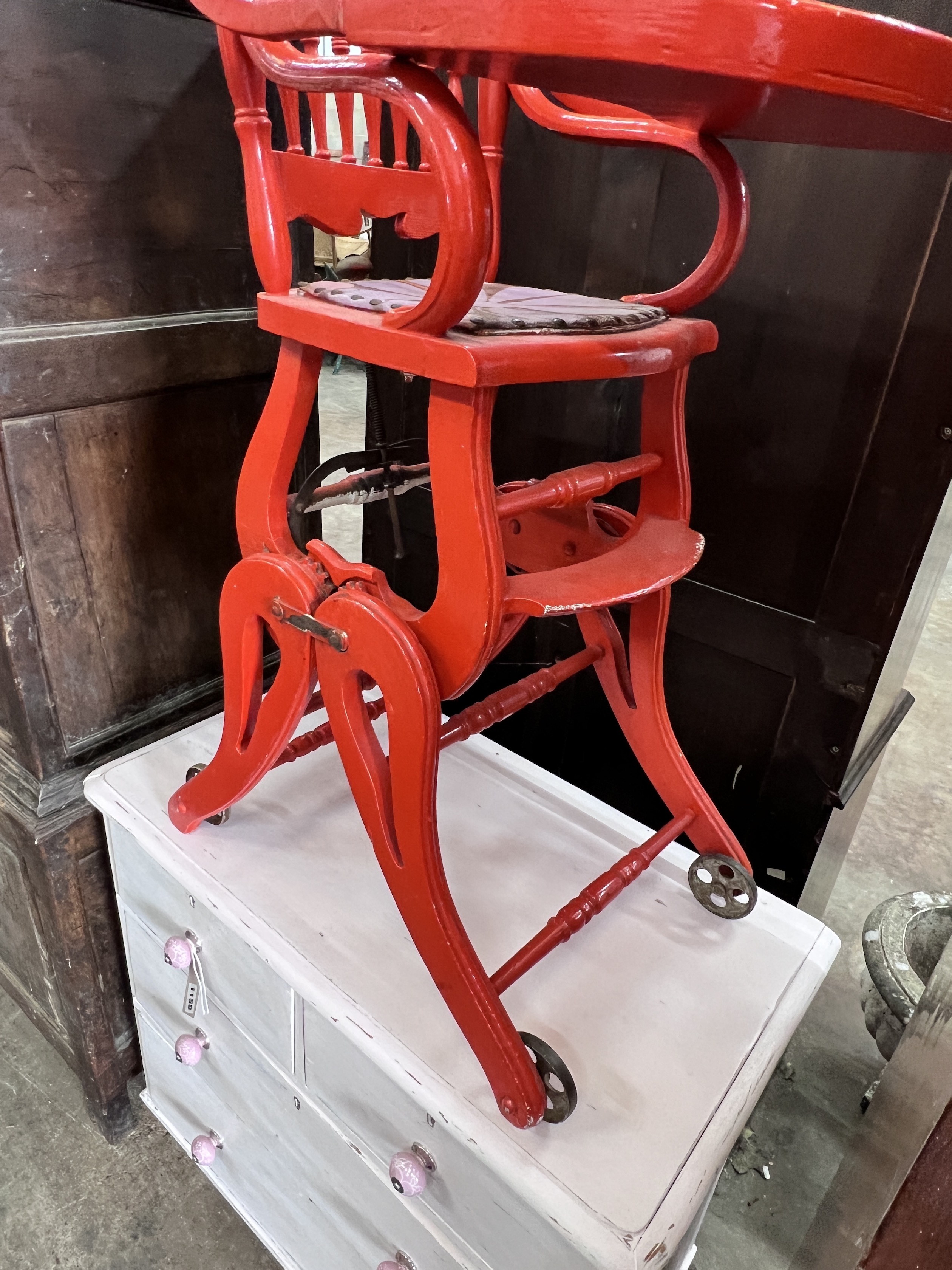 An early 20th century child's metamorphic high chair, later painted red